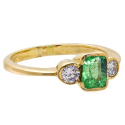 MID CENTURY RING. 18ct Gold. 0.65 Carat EMERALD. TWO 0.25 CARAT DIAMONDS.. Click for more information...